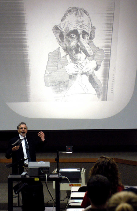 Dr. George Herring presented an interesting cartoon of Lyndon B. Johnson during an afternoon lecture on "The Reluctant Warrior: LBJ as Commander in Chief."  Dr. Herring was the speaker at the 2005 Carls-Schwerdfeger History Lecture Series. - Photo by Morris Abernathy