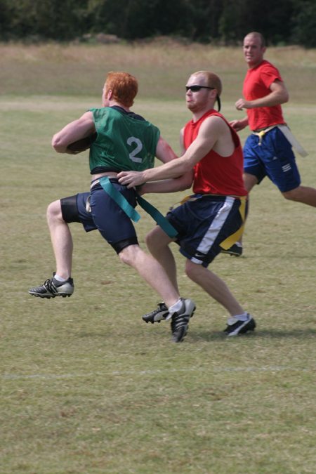 Junior Clay Manley goes for Sophomore Jack Smothers' flag as Junior Brett Jenkins looks on during a Family Weekend flag football game. - Photo by Kyle Kurlick