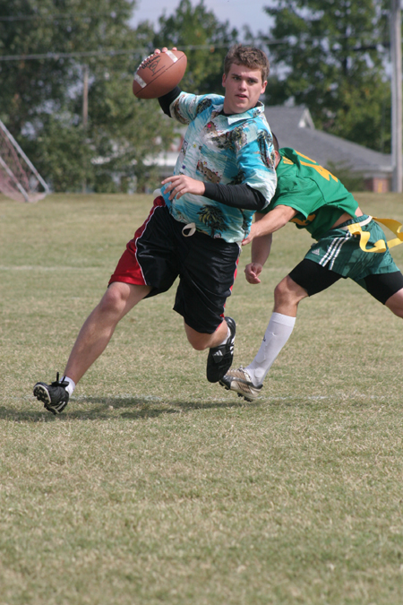 Senior Clayton Sanderson tries to avoid a Lambda Chi defender during a Family Weekend flag football game. - Photo by Kyle Kurlick