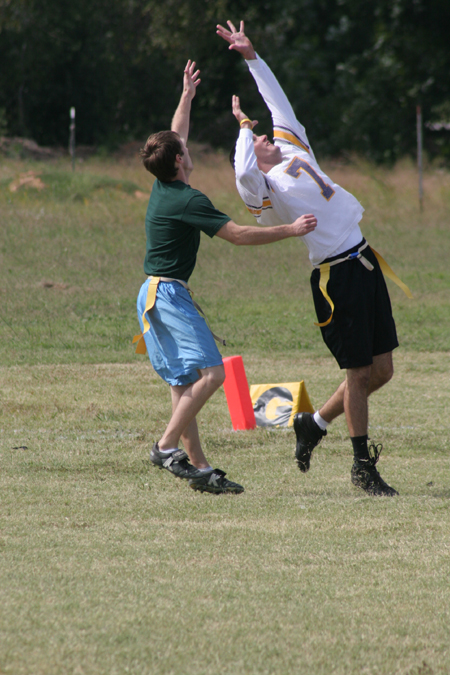 Senior Derek Carson and Junior Chris Brown reach for the ball as it comes their way during a Family Weekend flag football game. - Photo by Kyle Kurlick