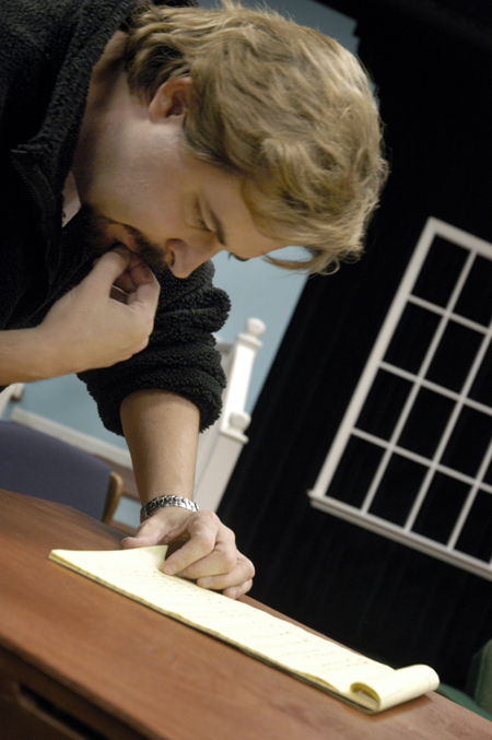 Darren Michael, assistant professor of theatre, goes over his notes before the premiere of <i>Tartuffe</i>. - Photo by Kathleen Murray