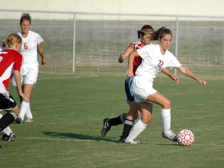 Charity Carter (22) battles a Martin Methodist player for ball possession. - Photo by Steven Aldridge