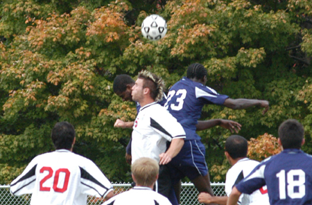 Scott Sinclair jumps with a two Missouri Baptist players as they battle for the ball. - Photo by Steven Aldridge