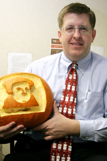 Assistant Professor of Christian Studies Ray Van Neste holds the "Luther-o-lantern" three of his students gave him on Reformation Day. - Photo by Kyle Kurlick