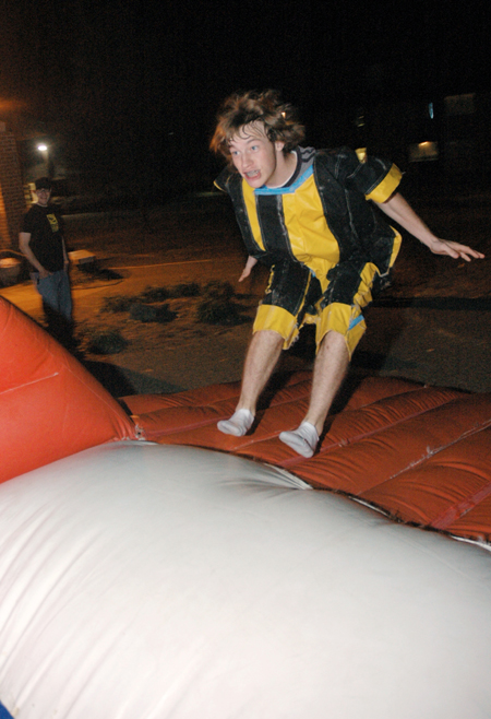 Freshman Dustin Nelson bounces toward the inflatable velcro wall during Fallapalooza. - Photo by Brad Moore