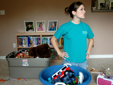 Senior Jessica Cherry contemplates what to do next while helping clean and organize the house of a mother and her three children during the Day of Remembrance. - Photo by Brad Moore