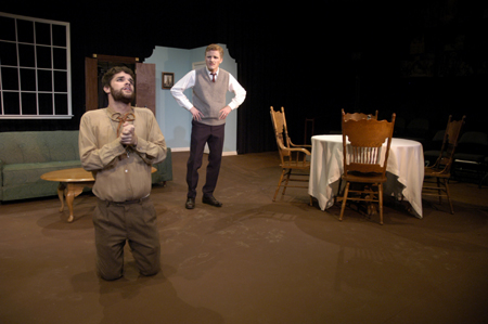 Aaron Shepherd begs for mercy from Andy Morris in <i>Tartuffe</i>. - Photo by Kathleen Murray