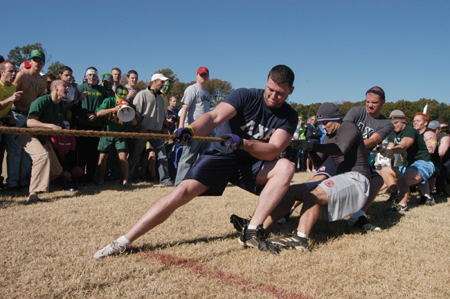 The Lambda Chi Alphas dig in during the tug of war at the Greek Olympics. - Photo by Heather Phillips