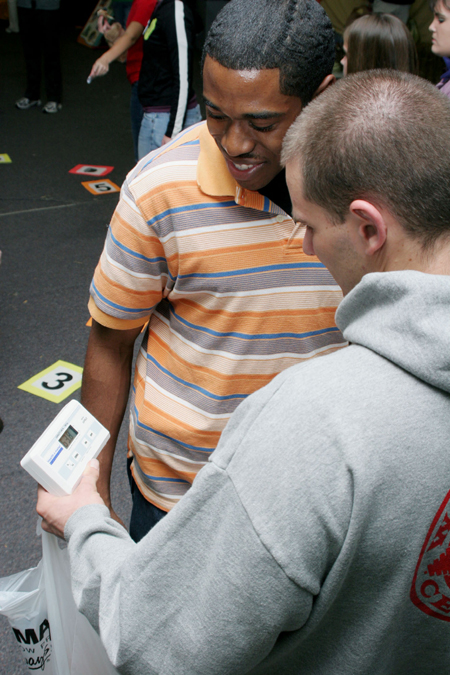 Ian Ellis shows Derrick Anderson his new purchase during the Junior/Freshman Party. - Photo by Kyle Kurlick