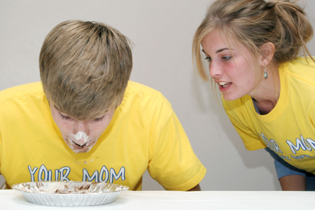 Junior Heather Childers encourages Freshman Stephen Lynch at the pie eating contest during the Junior/Freshman Party. - Photo by Kyle Kurlick