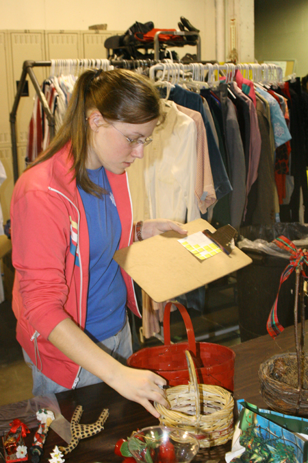 Sophomore Jill Casey separated clothing at RIFA during Alpha Psi Omega's Day of Remembrance service project. - Photo by Derek Ownby