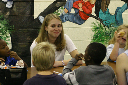 Project Leader Katie Mathis spent time with students at South Elementary during her Day of Remembrance service project. At this project, students ate lunch with and supervised the students as they had a fun filled afternoon with a movie and popcorn while the teachers took a break. - Photo by Derek Ownby