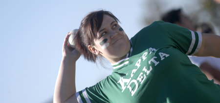 Senior Leslie Brown hurls a softball for Kappa Delta during the Greek Olympics. - Photo by Kathleen Murray