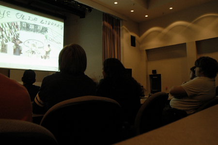 Students came out to view student films at the Third Annual Union Student Film Festival. In the foreground, Sophomore Lori Cunningham interprets one of the movies for Sophomore Adam Winter. - Photo by Kathleen Murray