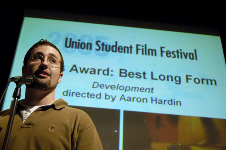 Sophomore Filmmaker Aaron Hardin accepts his award for Best Long Form Film for <i>Development</i> during the Third Annual Union Student Film Festival. This award came with editing software from Avid. - Photo by Kathleen Murray