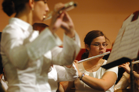 The flute section concentrates on their music during a Symphonic Band concert. - Photo by Brad Moore