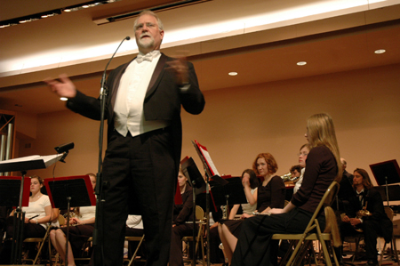 Conductor David McClune introduces a piece during a Symphonic Band performance. - Photo by Brad Moore