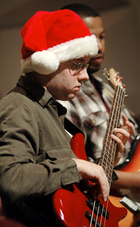 Senior Nathan Webb played the guitar with Christmas spirit during the Jazz Band Concert. - Photo by Brad Moore