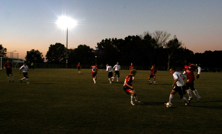 The men's soccer teams scrimmage on the new soccer field on a fall night. - Photo by Morris Abernathy