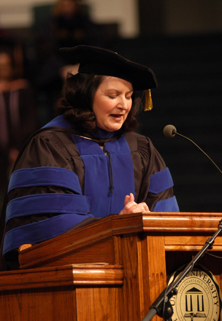 Social work professor and graduate parent Terry Blakley gives the invocation during the 2005 fall graduation ceremony. - Photo by Morris Abernathy