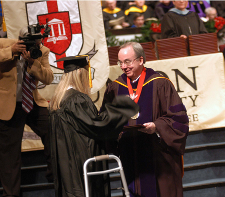 Alisha Michelle Pinner receives her bachelor of science in psychology from President Dockery during fall graduation. - Photo by Morris Abernathy