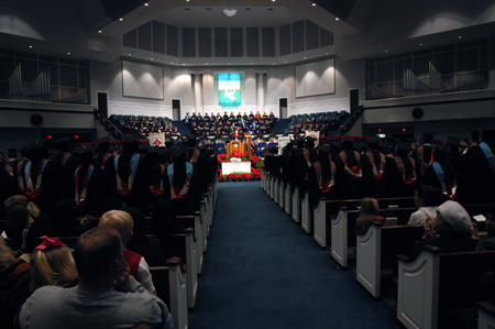 President Dockery congratulates the new graduates at the end of fall graduation. - Photo by Morris Abernathy