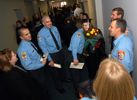 Sara Sanders is congratulated by Jackson's Finest after receiving her bachelor of arts degree in art during fall graduation. - Photo by Morris Abernathy