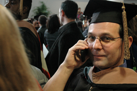 MBA Graduate Dean Garner searches for his family amidst the sea of people following the fall graduation ceremony. - Photo by Brad Moore