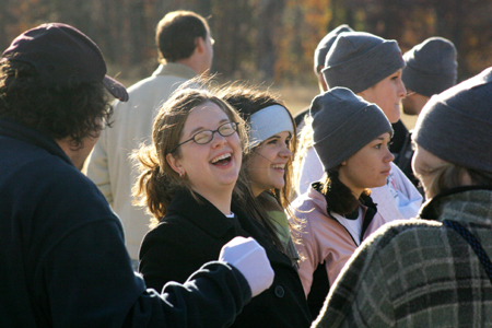 Senior Annie Ross and Sophomore Josh Clarke enjoy a laugh during the Turkey Bowl while Junior Keely Hart and Sophomore Bekah McElhannon watch the excitement on the field. - Photo by Kyle Kurlick