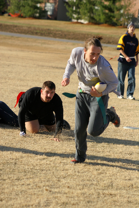 Sophomore D.L. Fruge runs past sophomore Stephen Ellis with the bird during the Young Alums' Turkey Bowl. - Photo by Kyle Kurlick