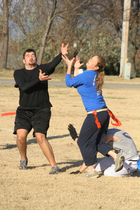 Sophomores Stephen Ellis and Jessica Ramsay both go for the bird during the Young Alums' Turkey Bowl. - Photo by Kyle Kurlick