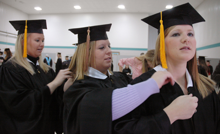 Suzanne Fitzpatrick, Cheslea Crowson and Crystal Gibson make final preparations before Fall Graduation 2005. - Photo by Kristen Nicole Sayres