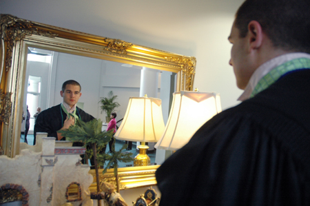 Graduate Ian Ellis ties his tie before December graduation. - Photo by Kristen Nicole Sayres