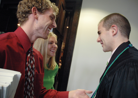 Alum Nathan Robertson and student Crystal Kinser help Ian Ellis prepapre for fall graduation. - Photo by Kristen Nicole Sayres