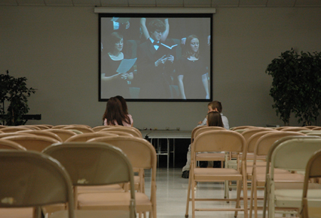 Several children watch December graduation in the overflow room at West Jackson Baptist Church.
 - Photo by Kristen Nicole Sayres
