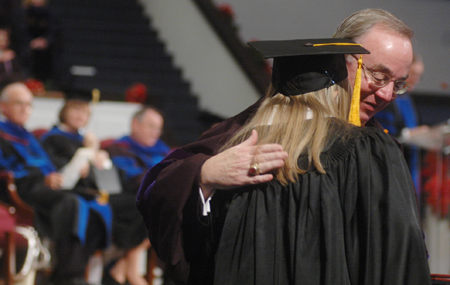 Encouragement and love in hug from President Dockery during Fall Graduation 2005. - Photo by Kristen Nicole Sayres