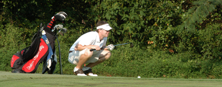 Sophomore Drew Cannon eyes his put during one of the Union men's golf practice rounds. - Photo by Heather Phillips