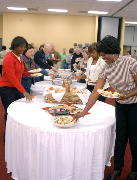 Wende Jackson makes a selection at the Family Weekend Brunch, followed by her daughters, Jande and Wende. - Photo by Brad Moore