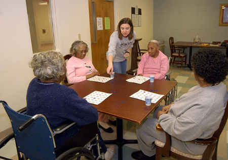 Julie Bradfield, director of student ministries, spends time with patients at Mission Convalescent Home in Jackson on Martin Luther King, Jr. Day. - Photo by Morris Abernathy