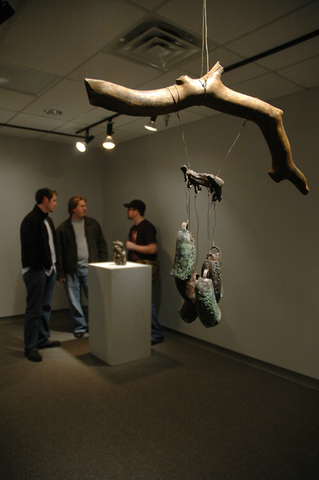 Josh Wilkerson, Ariel Gee and Aaron Hardin fellowship while admiring the art at the <em>Works In Bronze</em> show held in the art gallery. - Photo by Kristen Nicole Sayres