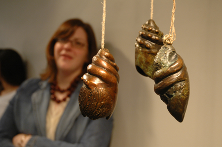 Zandrea Jackson admires some bronze shells during the <em>Works In Bronze</em> show held in the art gallery. - Photo by Kristen Nicole Sayres