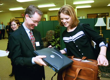 Union's Director of Computing Services John David Barham assists Heather Mercer with her laptop computer prior to her presentation in chapel. - Photo by Jim Veneman