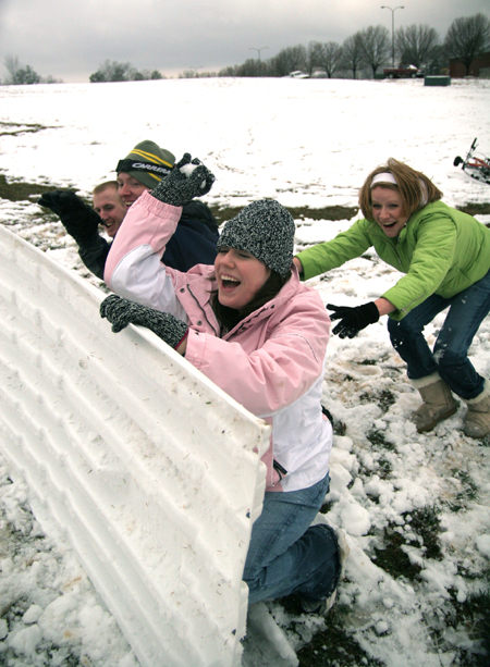 Brittany Sampson, Brian Burns, John Henson and Sarah Eastin take cover behind their makeshift fort during a snowball fight. - Photo by Kyle Kurlick