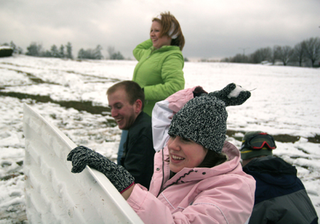 Brittany Sampson, John Henson, Sarah Eastin and Brian Burns keep the fun going during a snowball fight near the U. - Photo by Kyle Kurlick