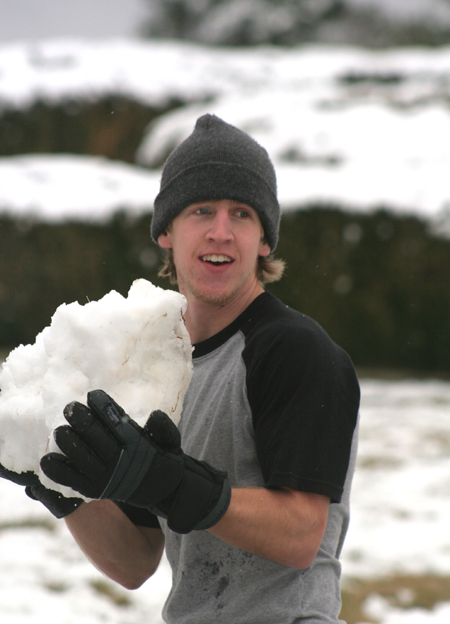 Drew Winter prepares to launch his massive snowball during a snowball fight at the U. - Photo by Kyle Kurlick