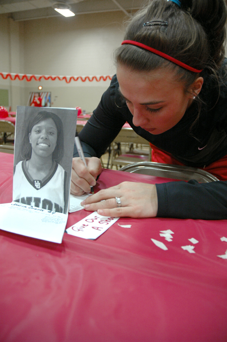 Fans came out for the World's Largest Tailgate Party to show their support the basketball teams by writing them supporting notes. - Photo by Brad Moore