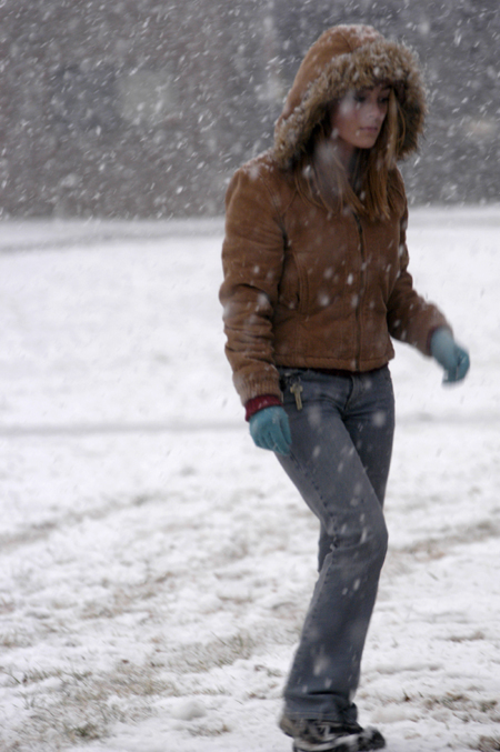 Tina Averill makes her way through a snow shower on the Union campus. - Photo by Stephanny Rodriguez