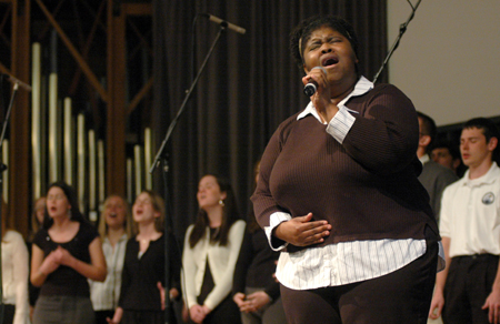 Crystal Taylor, director of the gospel choir, sings with the gospel choir during chapel. - Photo by Brad Moore