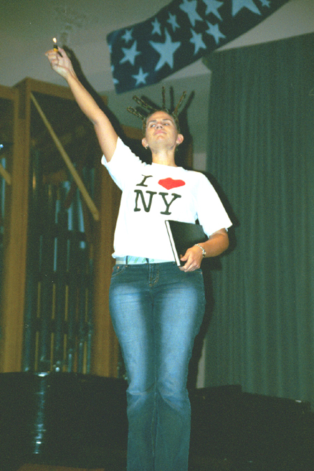 Biology major Tiffany Windall imitates the Statue of Liberty for the Junior Class during the SAC Variety Show. - Photo by Lindsay Stavish