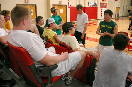 Bryan Spillman discusses strategy for the Wild and Wacky Homecoming Games with fellow Lambda Chis. - Photo by Brad Moore